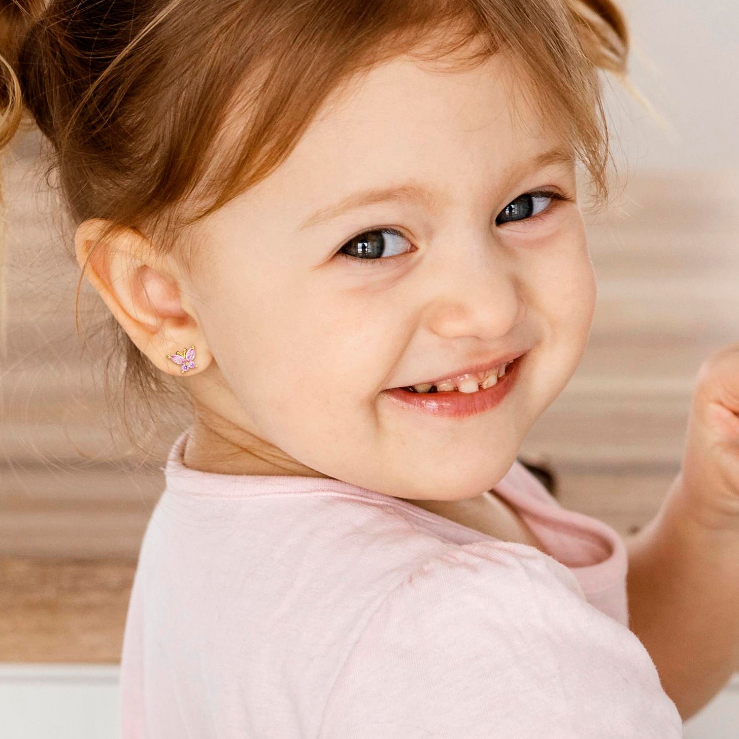 Baby Girl Wearing Crystal Butterfly Earrings